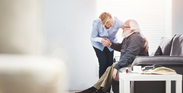 dementia-caregiver-assisting-elderly-man-home