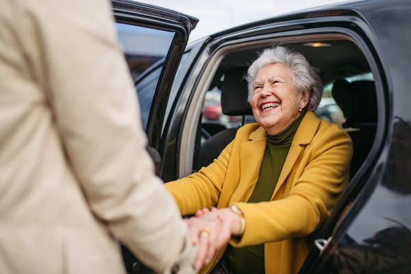 dementia-senior-woman-exiting-car-assistance