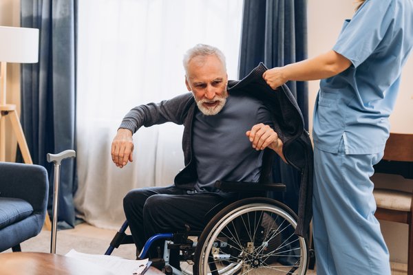 health-elderly-man-wheelchair-caregiver-assistance